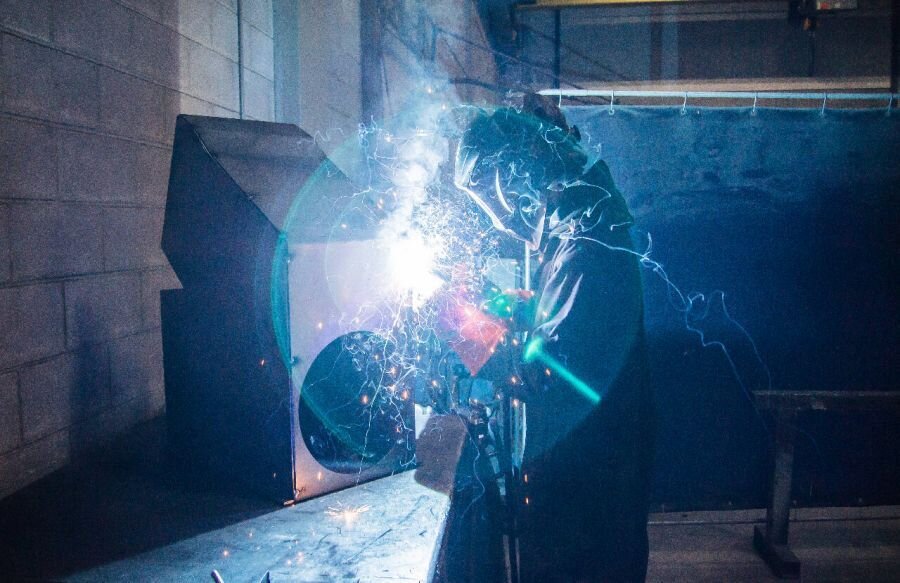 Welder working on grain equipment fabrication